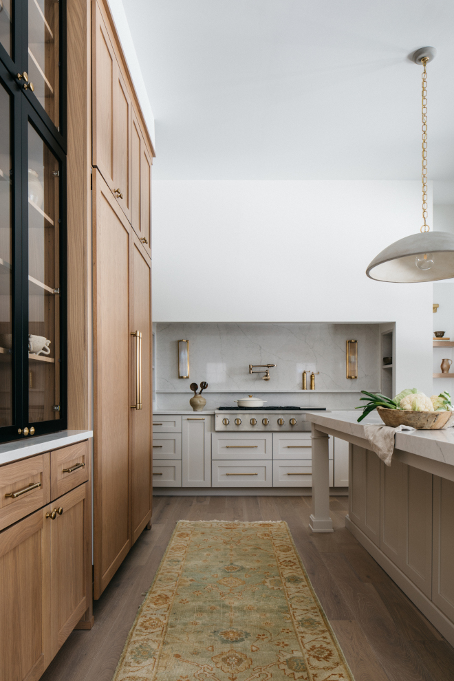 2026-new-home-kitchen-perimeter-cabinets-gossamer-veil-vanilla-milkshake Perimeter kitchen cabinets in white oak Warm Gray, wall cabinets in Sherwin Williams Gossamer Veil, and custom hood painted Vanilla Milkshake with MSI Calacatta Monaco backsplash in a 2026 new home.