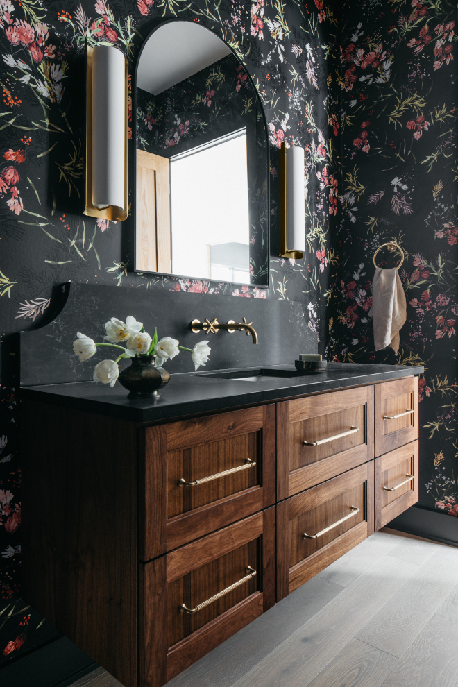 2026-new-home-powder-room-peppercorn-vanity-midnight-corvo Powder room with custom Walnut vanity in Peppercorn stain, MSI Midnight Corvo concrete-finish countertop and backsplash, and moody floral wallpaper in a new construction home.