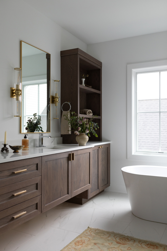 Primary bathroom vanity with white oak cabinets in a warm gray stain and dual sinks.