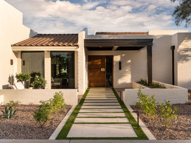 Mid-century modern Arizona home courtyard and front porch with tile roof, clean lines, and sculptural outdoor lighting, creating a welcoming and timeless entrance.