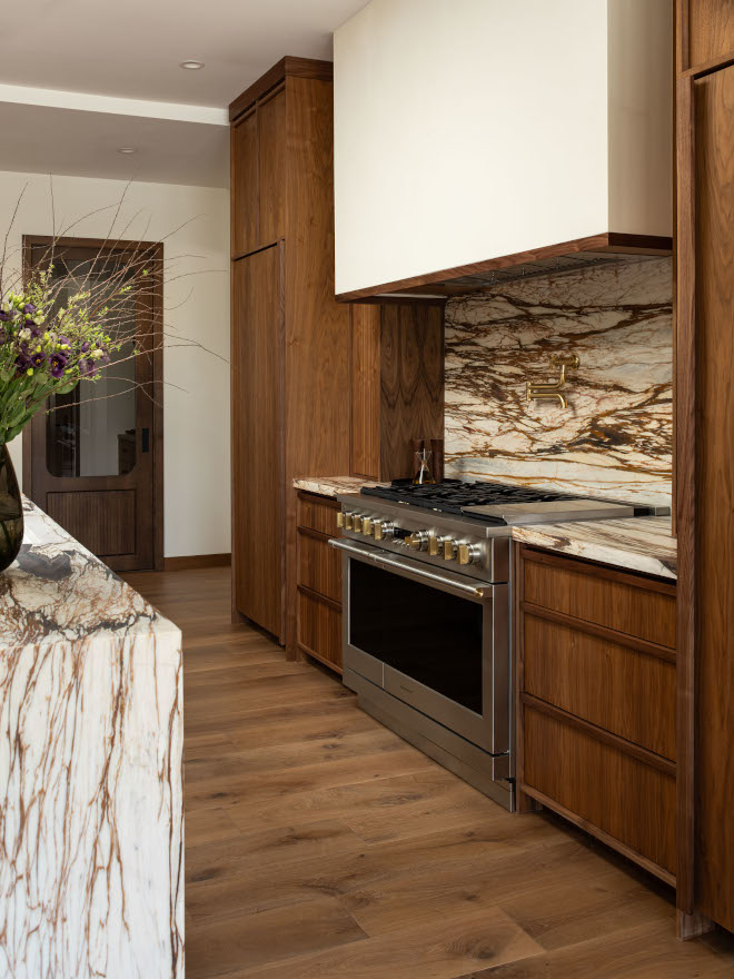 Arizona mid-century modern kitchen with rich walnut perimeter cabinets, wall painted in Sherwin Williams DEW340 Whisper, glass-front cabinets, and coffee station, showcasing warmth and mid-century modern style.