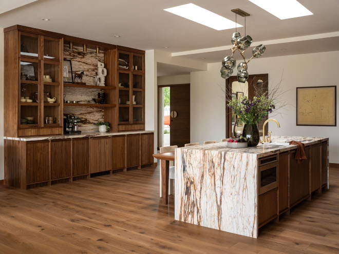Wall-to-wall kitchen cabinets with coffee station and glass-front doors, walls painted DEW340 Whisper complementing warm walnut cabinetry.