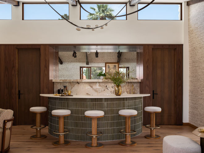 Mid-century modern lounge and bar area featuring walnut cabinetry, luxe brass accents, and Amalfi Silk Como wallcovering, blending warm neutrals and layered textures.