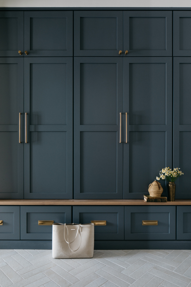 mudroom-night-out-lockers-white-oak-bench-herringbone-tile Mudroom with custom lockers painted Sherwin Williams Night Out, white oak bench, and herringbone porcelain floor tiles.