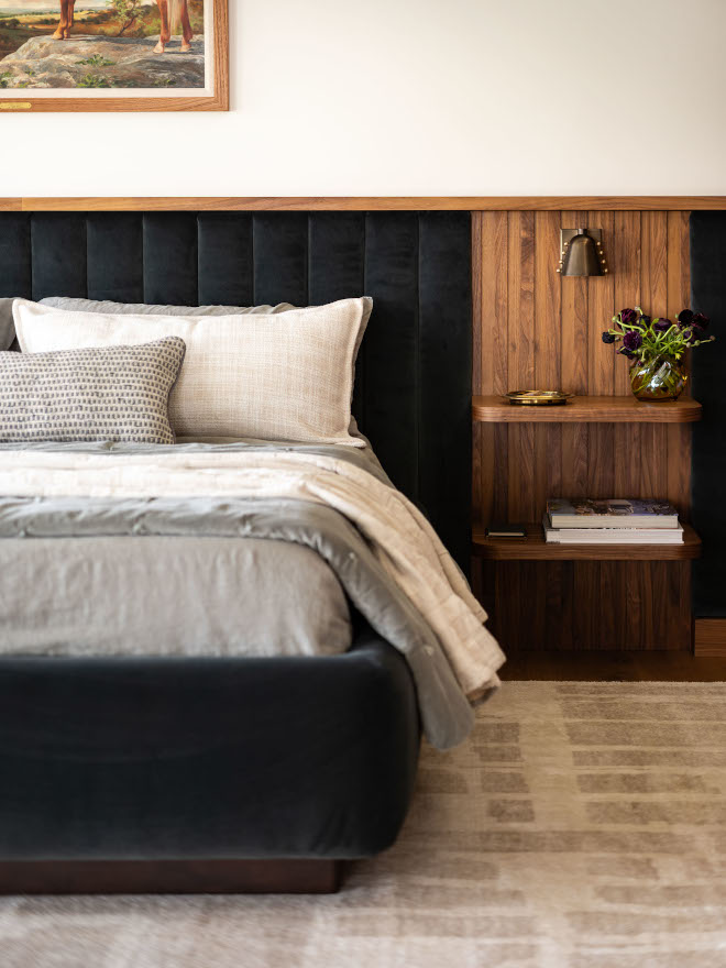 Close-up of mid-century modern bed and walnut nightstand in guest bedroom, showing velvet upholstery and wood detailing.