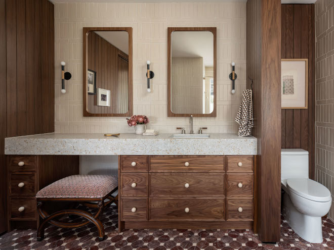 Bathroom vanity with walnut cabinetry, thick mitered terrazzo countertop, and wall-to-ceiling tile backsplash in vertical-stacked crosshatch pattern.