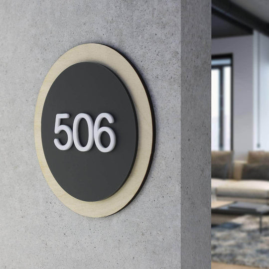 Close‑up detail of a sleek apartment number sign with readable typography and quality finish