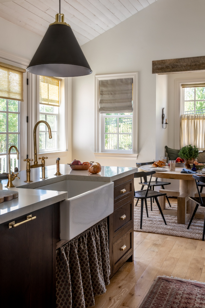 French Country kitchen featuring a dark stained island with Minwax Provincial finish, marble-look quartz countertop, unlacquered brass faucet, and rustic reclaimed wood counterstools