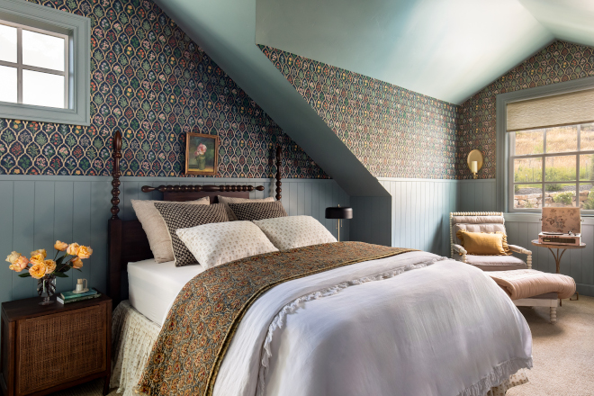Mountain home bedroom with Farrow and Ball Oval Room Blue wainscot and ceiling, floral botanical wallpaper, spindle poster bed, and ruffled duvet