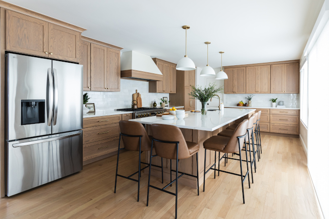 Kitchen-Renovation-White-Oak-Cabinets-Island Bright kitchen renovation with custom white oak cabinets, large island with seating for six, quartz countertops, and full wall of windows
