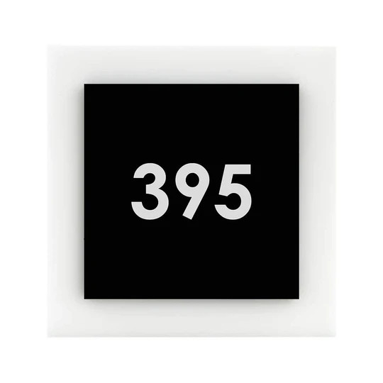 Contemporary minimalist apartment number sign mounted on a residential door, featuring clean lines and sleek modern design