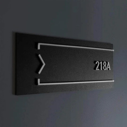 Modern and minimalist apartment number sign mounted on a residential door with clean lines and sleek design
