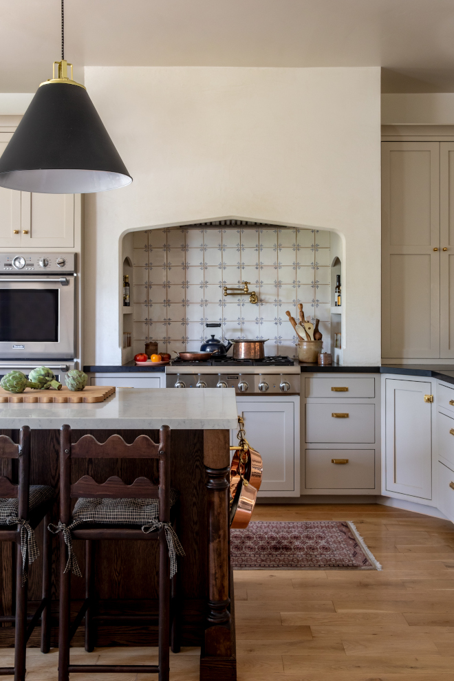 French Country kitchen painted in Benjamin Moore Bone, featuring light taupe cabinets, marble-look quartz countertops, hand-painted Portuguese tile backsplash, and warm neutral tones with layered textures