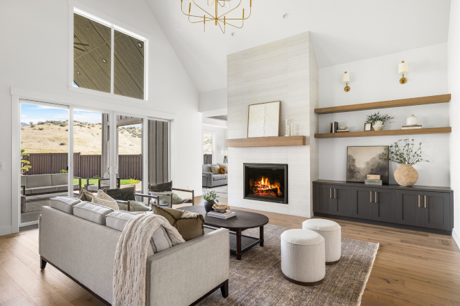 Floor-to-ceiling fireplace with vaulted ceilings and Urbane Bronze cabinets in Idaho home