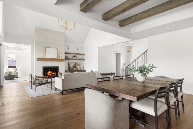 Dining room opening to great room with Sherwin Williams Alabaster walls in Idaho new construction home