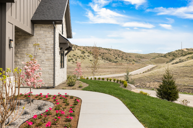 Idaho new construction exterior showing stone, siding, and awning with corbels painted Sherwin Williams Urbane Bronze SW 7048