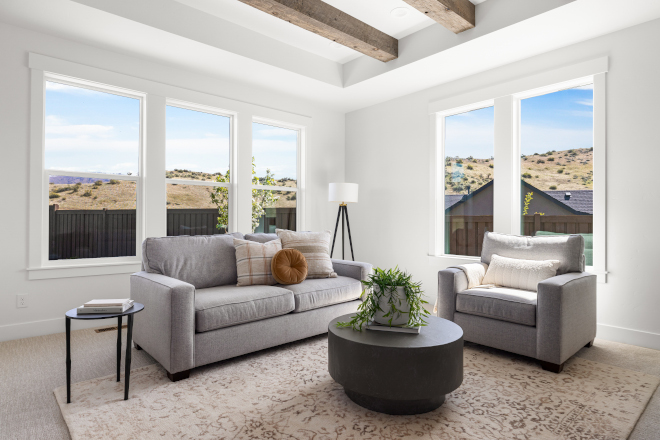 Family room with Sherwin Williams Alabaster walls and reclaimed box beams in Idaho new construction home
