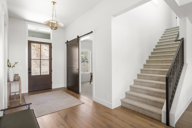 Idaho foyer with barn door painted Sherwin Williams Urbane Bronze
