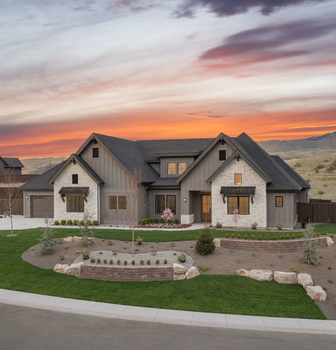 Modern Idaho new construction home exterior with mountain views at sunset painted Sherwin Williams Gauntlet Gray