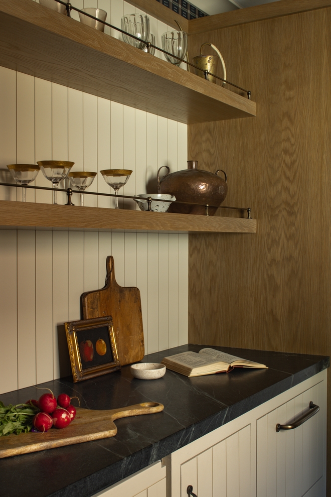 scullery wall with v groove backsplash white oak floating shelves and brass shelf rail styled with dishes and decor