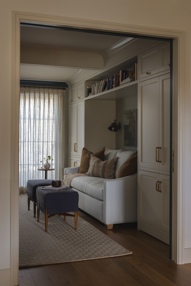 home office with custom built in cabinetry and cozy sofa nook painted Benjamin Moore Ballet White
