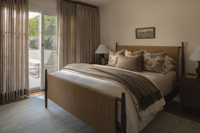guest bedroom with Benjamin Moore White Dove walls linen curtains and woven headboard bed