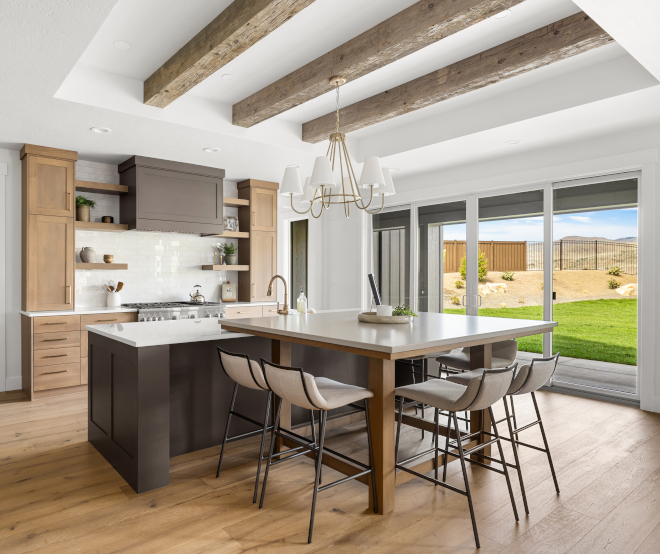 Large Idaho kitchen with expansive island, eating island, warm quartz countertop, and patio doors to backyard