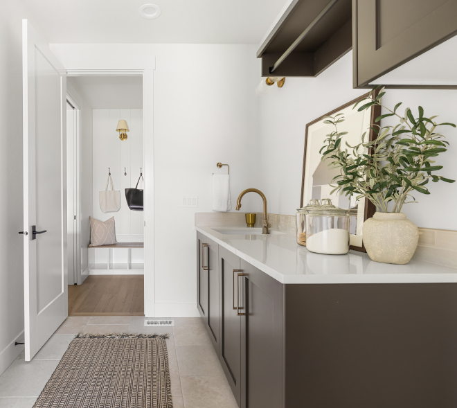 Laundry room with Sherwin Williams Urbane Bronze cabinets and Italian travertine porcelain ivory floor
