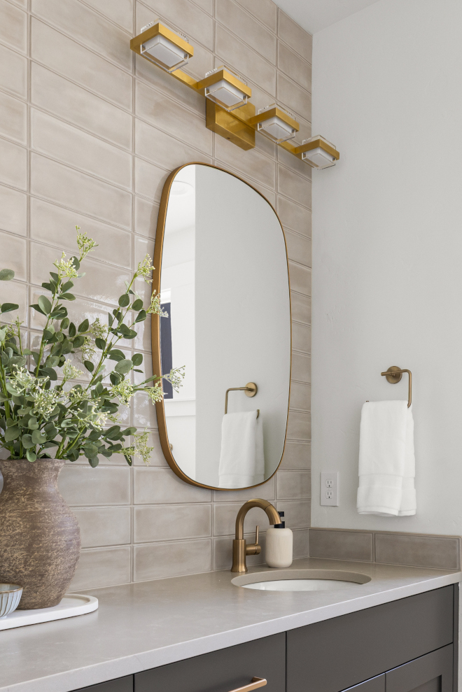 Close-up of taupe glossy horizontal accent tiles in primary bathroom