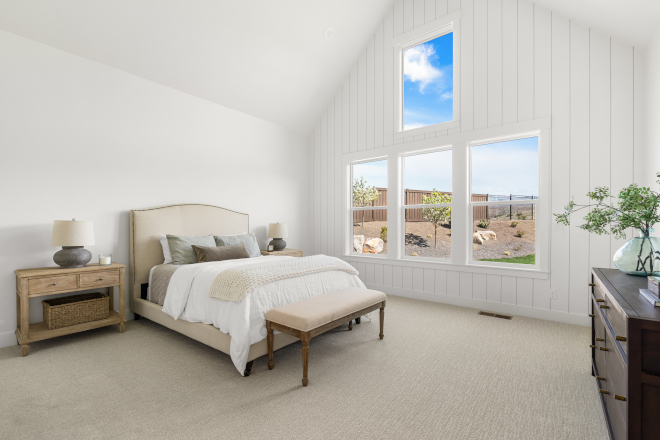 Primary bedroom with Sherwin Williams Alabaster walls and vertical shiplap accent wall