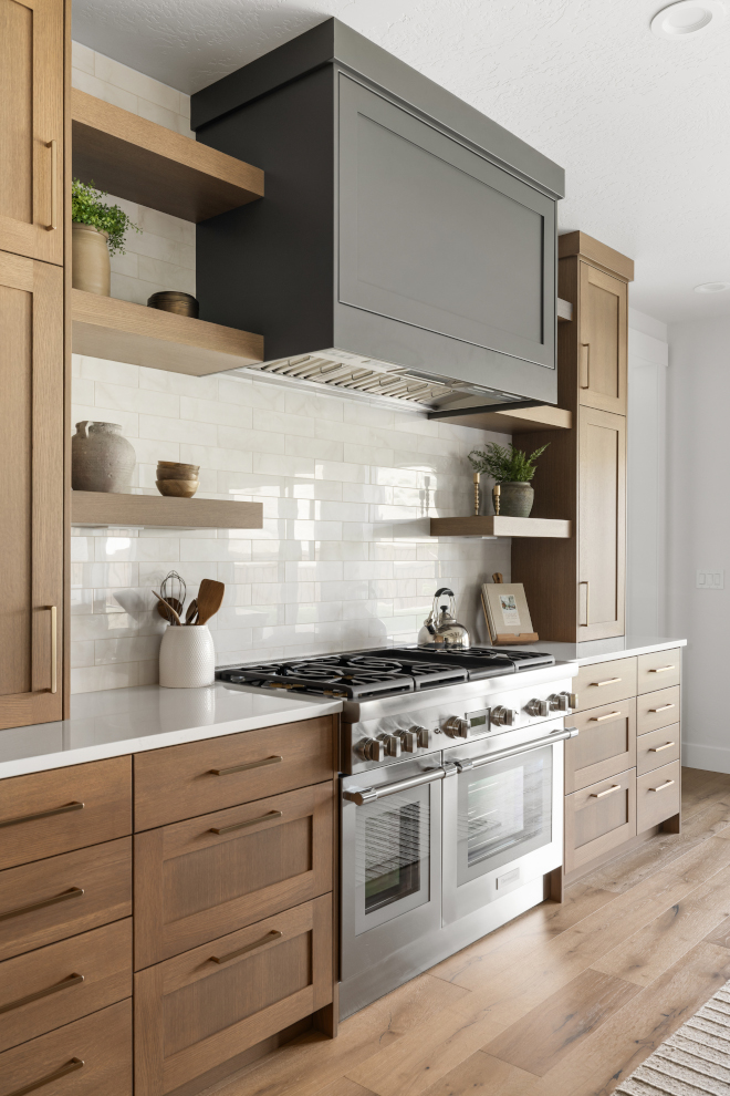 Kitchen range hood painted Sherwin Williams Urbane Bronze with floating shelves and Rustic Gray cabinets
