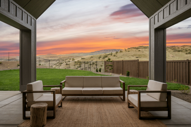 Two-story back porch with cathedral ceiling and mountain views in Idaho home