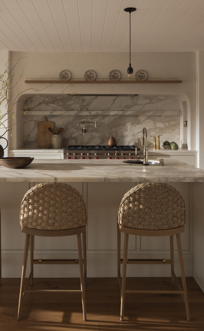 kitchen marble slab backsplash with warm neutral tones paired with Benjamin Moore Ballet White kitchen cabinets