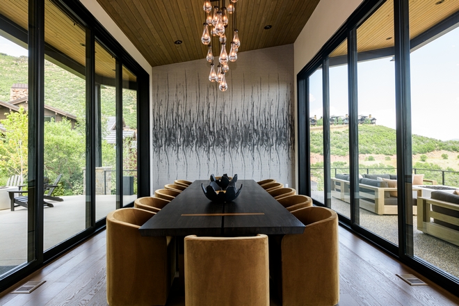 dining room surrounded by glass doors connecting to outdoor patio