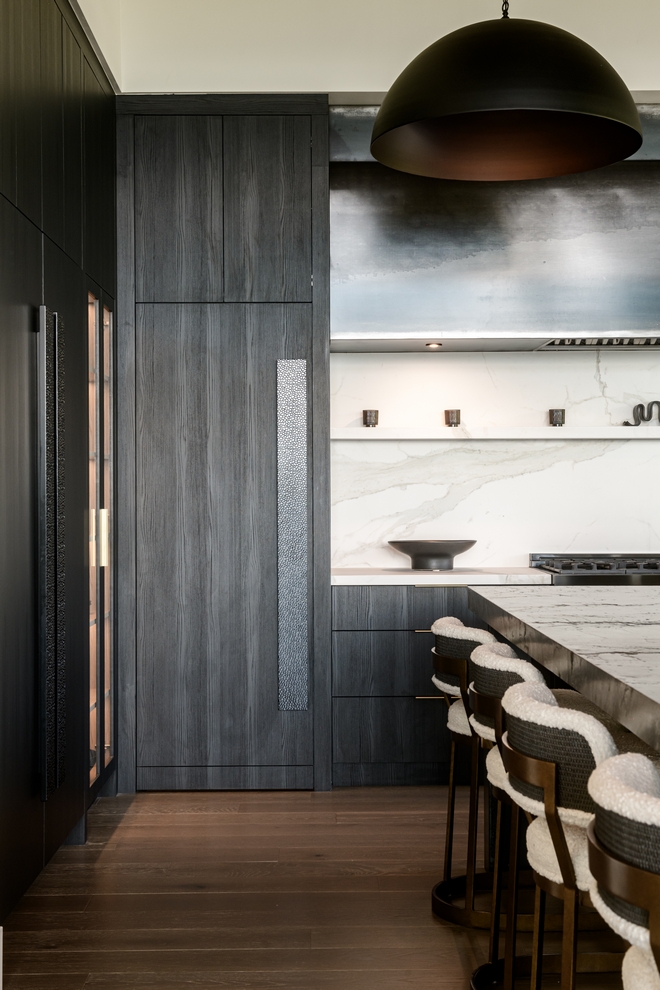 kitchen with dark wood cabinetry and white marble backsplash
