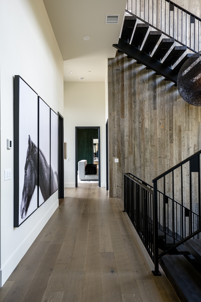 Benjamin Moore White Dove hallway with wood feature wall, modern staircase and artwork