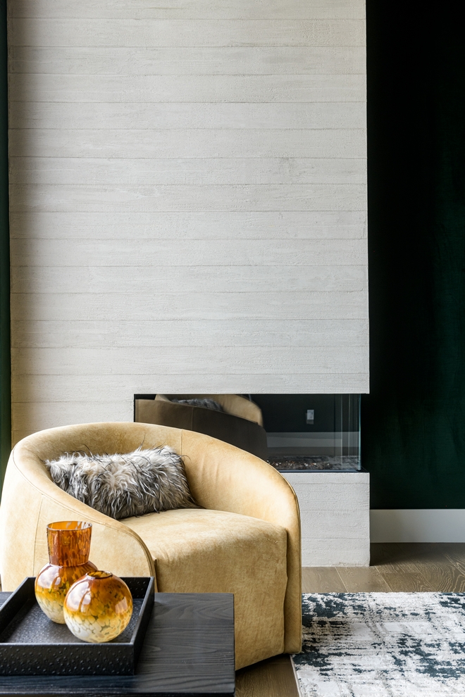 bedroom fireplace with modern surround and cozy chair