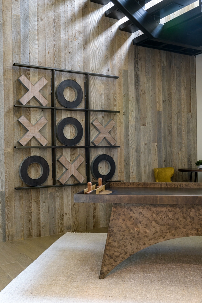 tic tac toe wall decor on wood accent wall in game room