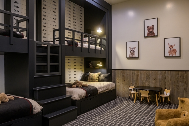 bunk room with built-in beds, wood accents and playful decor
