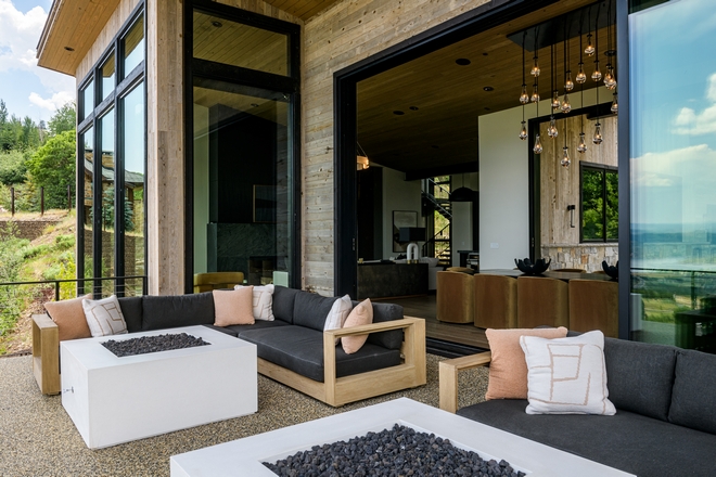 organic modern outdoor patio with neutral seating, fire table and indoor outdoor connection