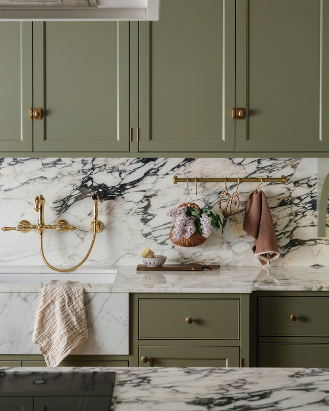 Traditional Kitchen with Green Cabinets Benjamin Moore Louisburg Green cabinets Marble Backsplash, and Brass Rail Styling #TraditionalKitchen #GreenCabinets #BenjaminMoore #BenjaminMooreLouisburgGreen #cabinets #MarbleBacksplash #BrassRailStyling