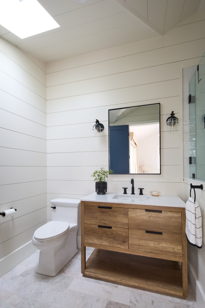 Coastal bathroom with Benjamin Moore White Dove shiplap walls, natural wood vanity, and matte black fixtures