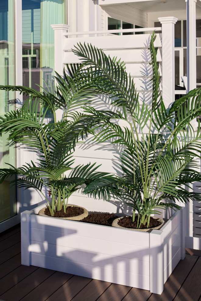 White coastal planter box with tropical palm plants on waterfront deck