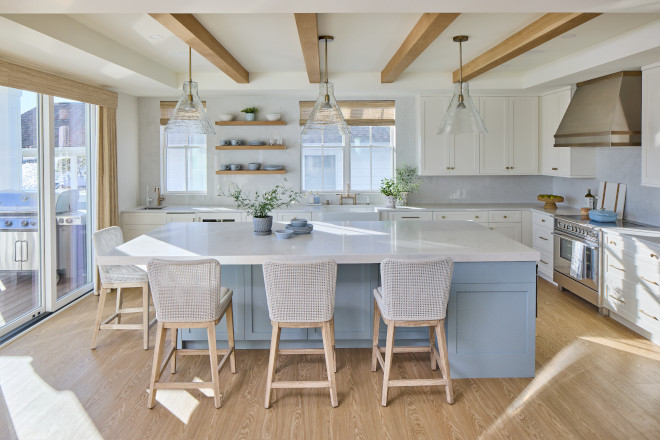 Coastal kitchen with Benjamin Moore Santorini Blue island, Benjamin Moore White Dove cabinets, and wood ceiling beams