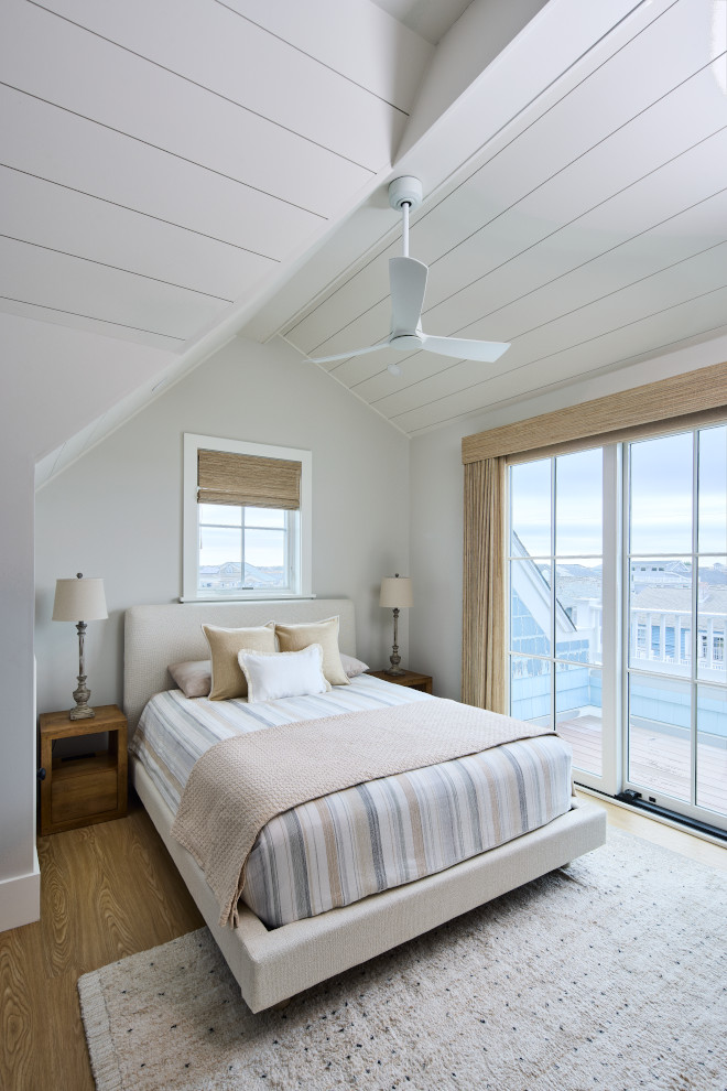 Coastal bedroom with Sherwin Williams Drift of Mist walls, vaulted white shiplap ceiling, and woven shades