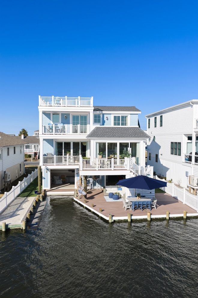 Coastal beach house designed with weather-resistant materials including fiber cement siding, PVC trim, flood vents, and durable exterior finishes for waterfront living