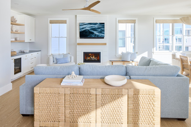 Woven console table behind pale blue coastal sectional with Benjamin Moore White Dove walls
