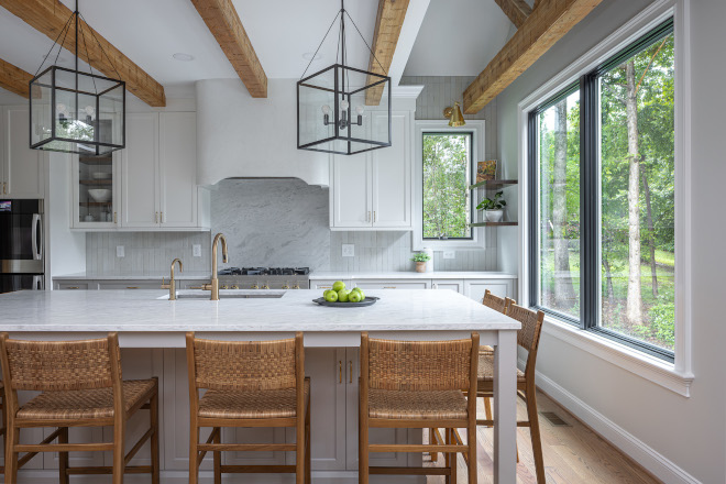 kitchen-island-lighting-benjamin-moore-steam-gray-owl Kitchen featuring Benjamin Moore Steam upper cabinets, Benjamin Moore Gray Owl lower cabinets and island, oversized lantern pendant lights, rustic wood beams, and a custom plaster range hood.