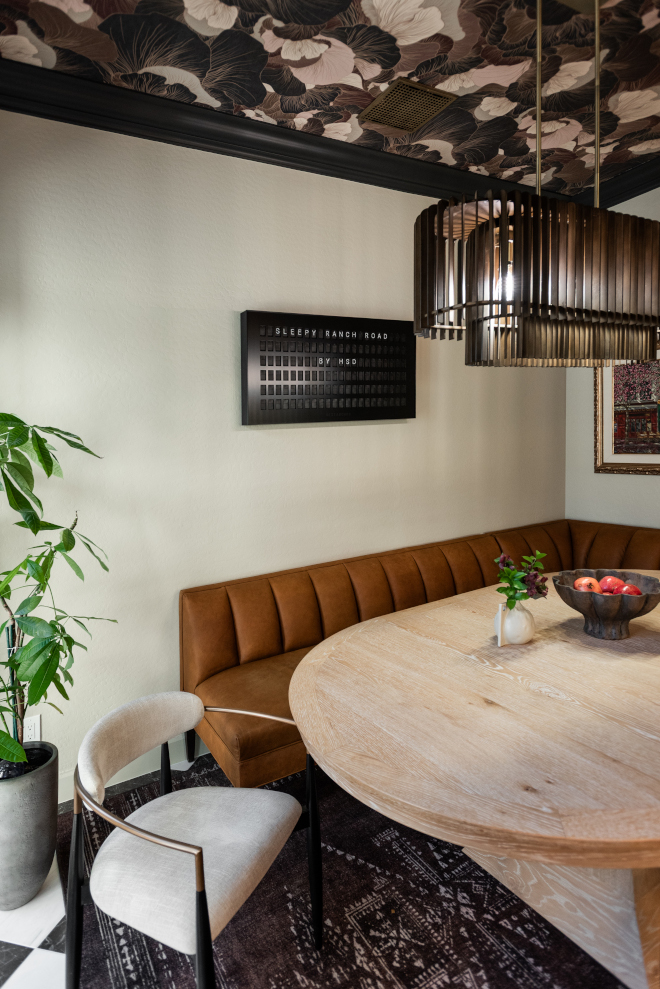 Dining-room-leather-banquette Custom curved leather dining banquette paired with a round oak dining table in a cozy breakfast nook.