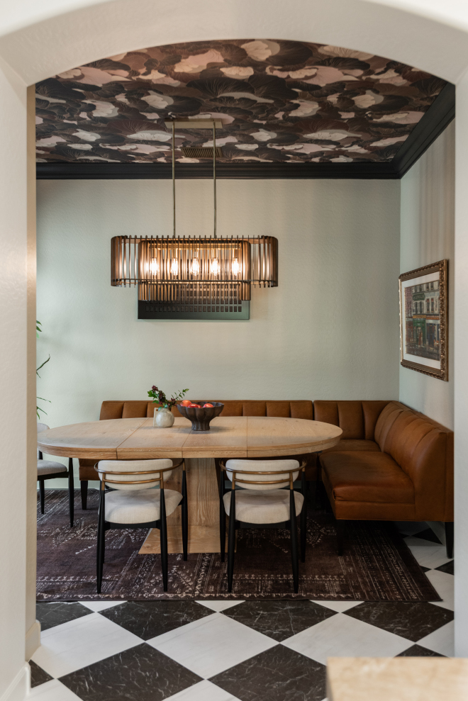 dining-room-leather-banquette-wallpaper-ceiling Dining room featuring a curved leather banquette, round oak table, statement chandelier and wallpapered ceiling.